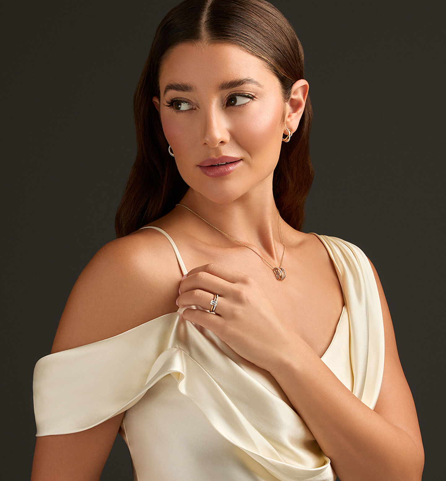 A woman wearing a Birks engagement ring and diamond jewellery.