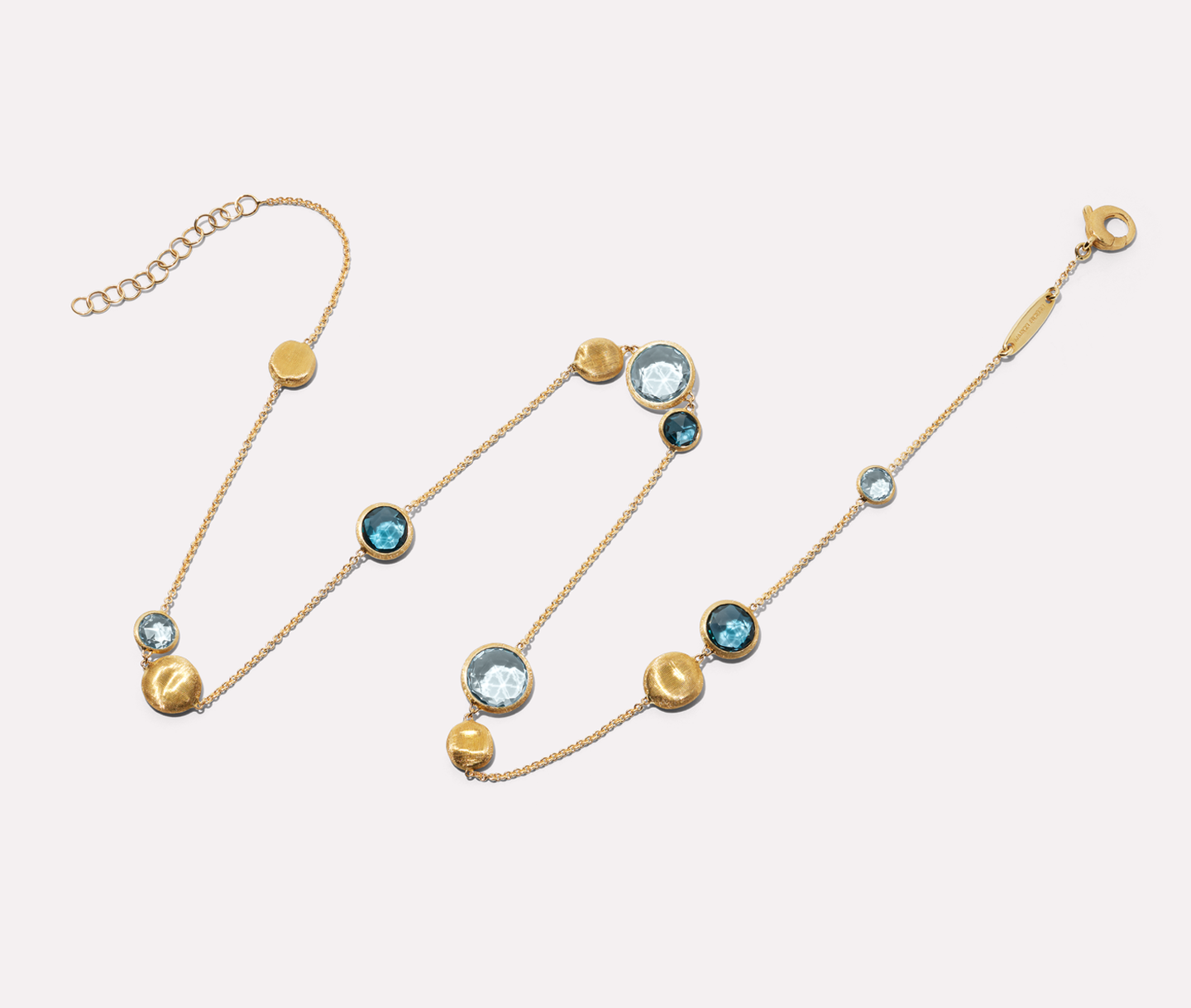 Marco Bicego jaipur gemstone necklace on a beige background.