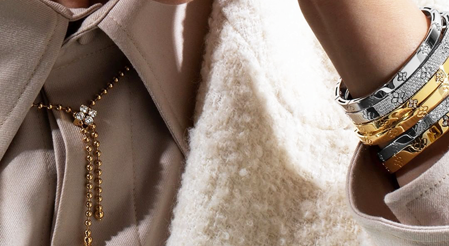 Model wearing gold Love in Verona bracelets.
