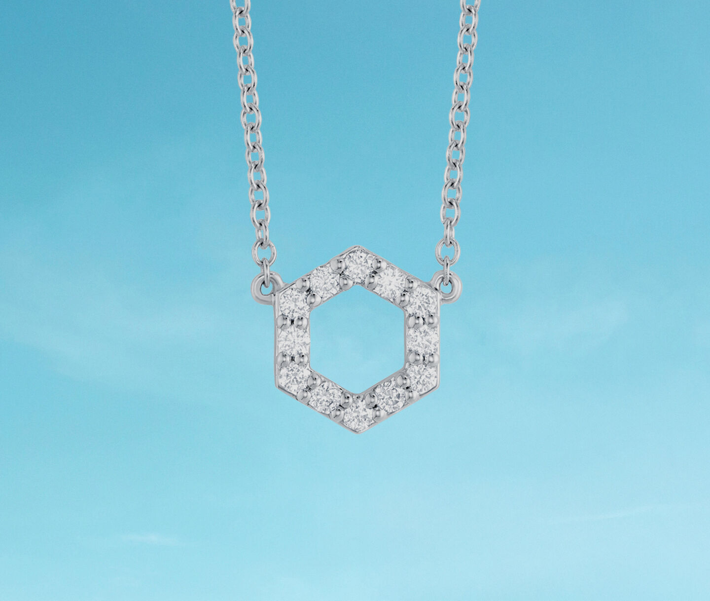 Birks Iconic diamond necklace on a blue background.