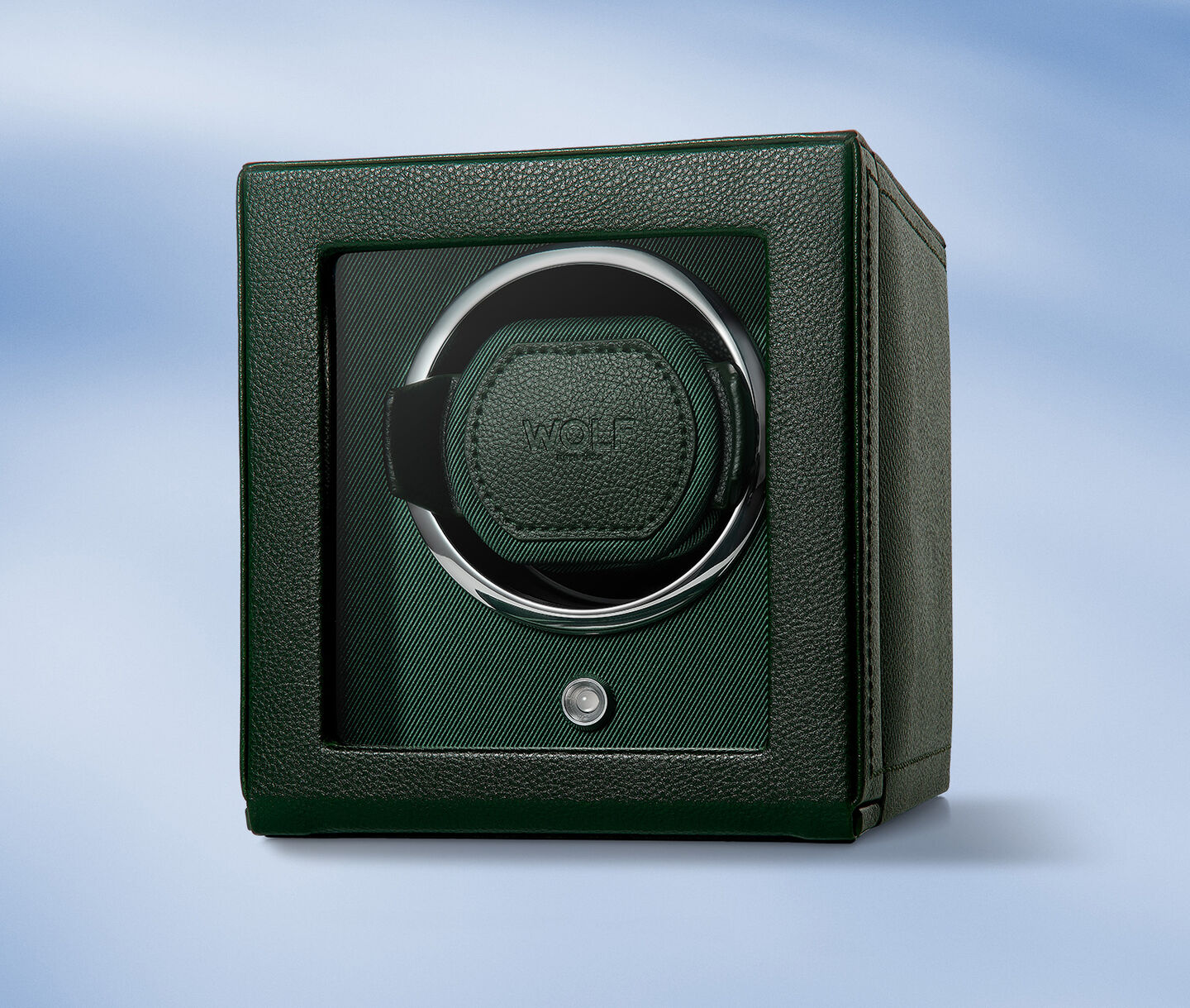 WOLF watch winder on a blue background.