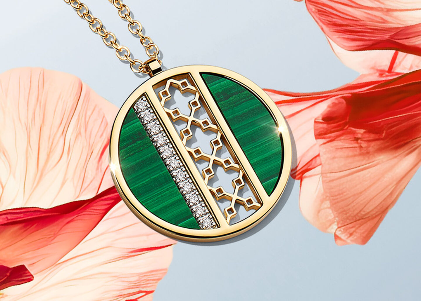 A Birks Dare to Dream malachite and diamond medallion on a pinkish orange flower and light sky blue background.