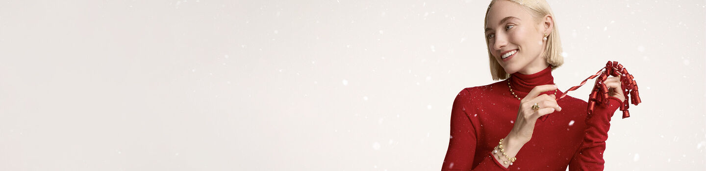 A woman wearing Maison Birks jewellery.