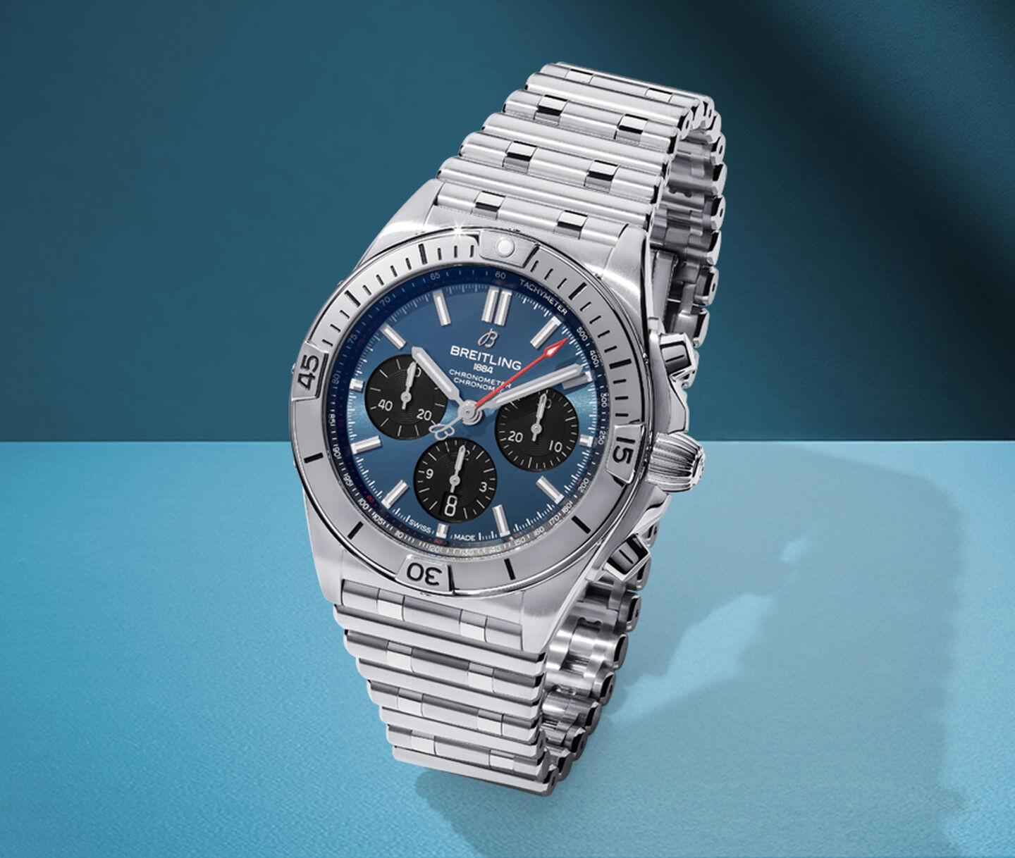 Breitling watch on a blue background.
