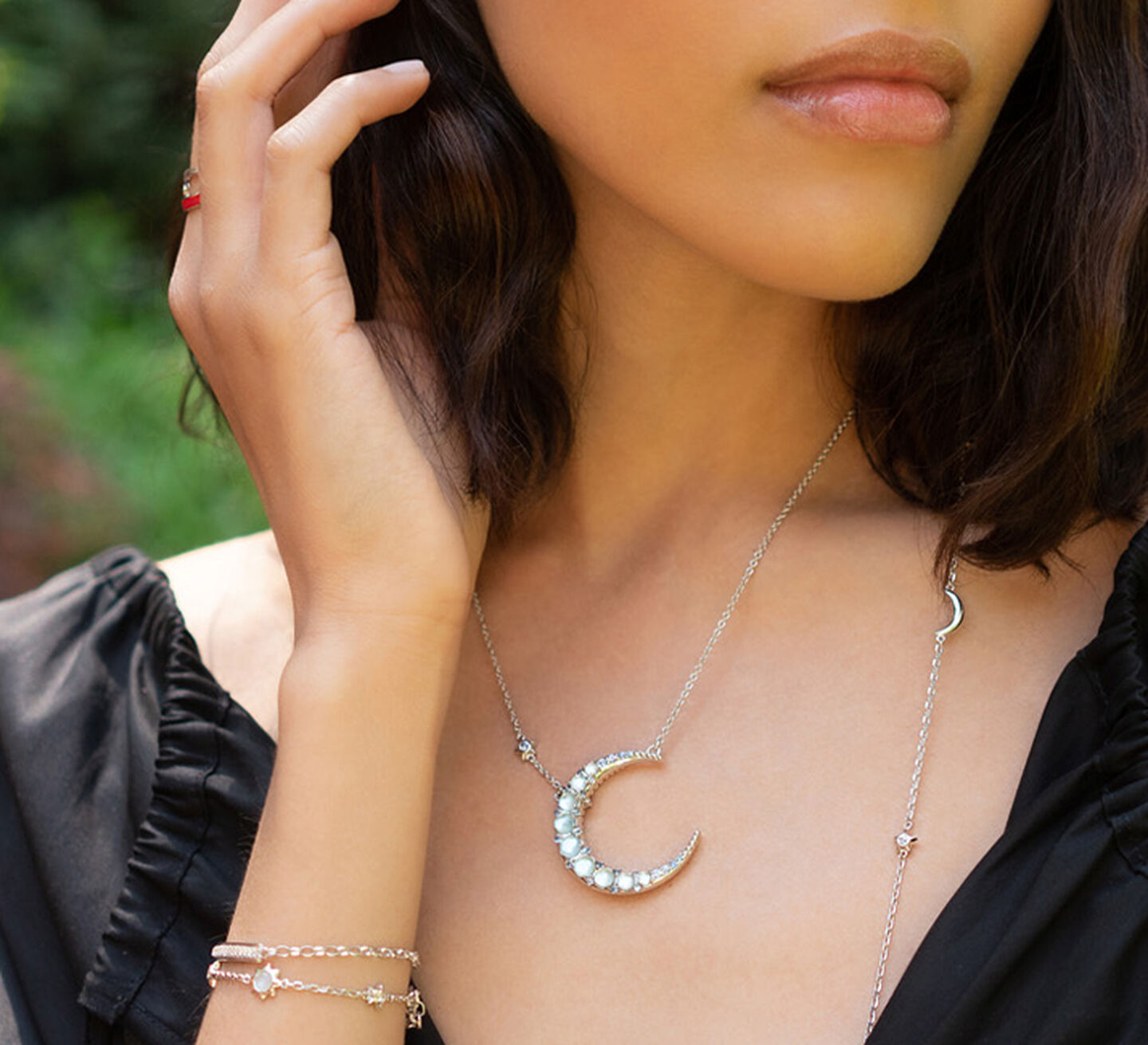 Model wears a silver and diamond moon charm
