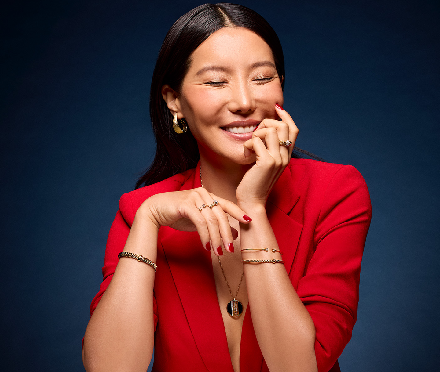 A woman in red wears jewellery from Maison Birks.