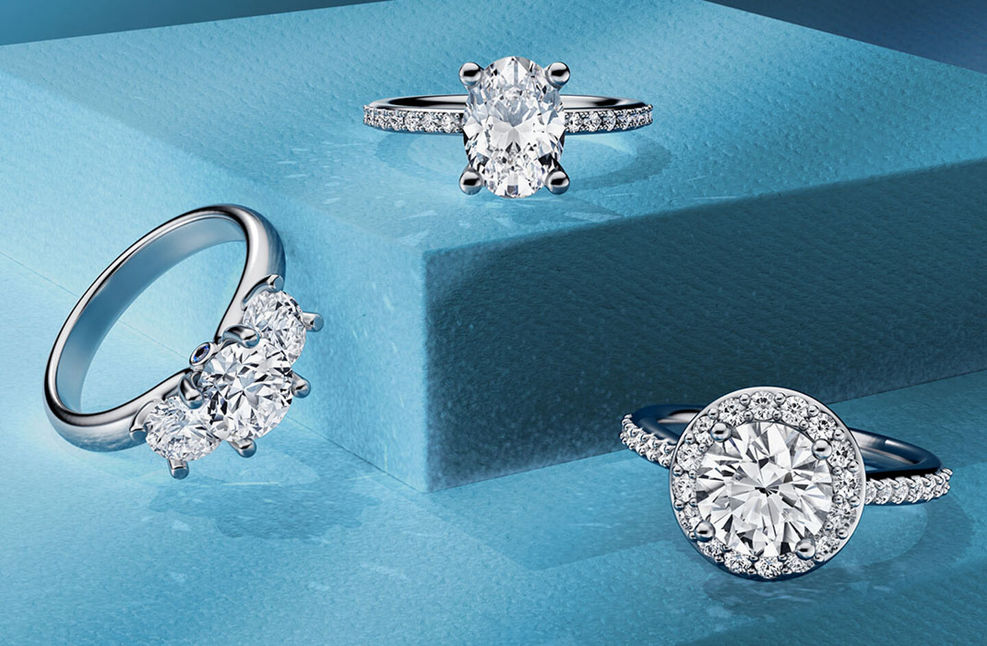 Birks diamond engagement rings on a blue background.