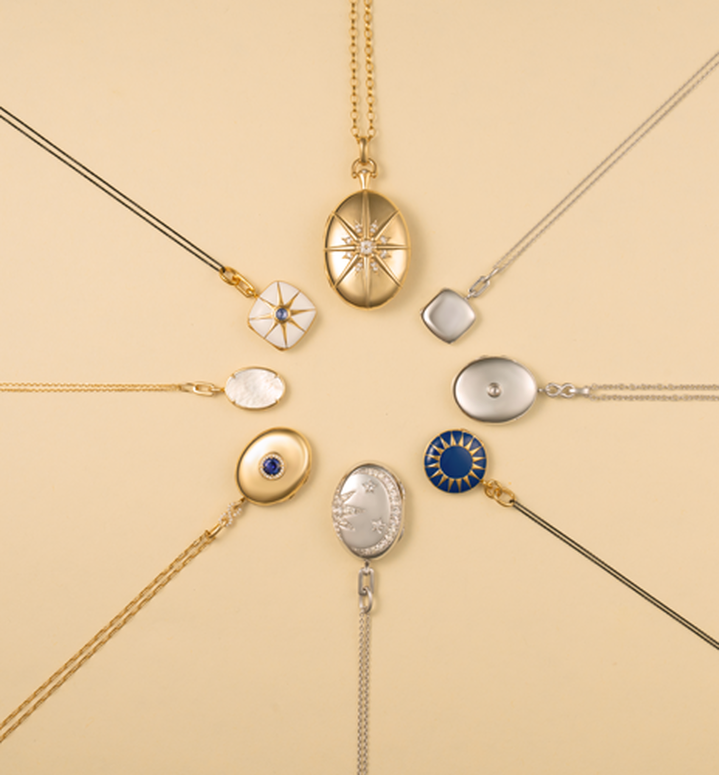 Monica Rich Kosann lockets on a pink background. 