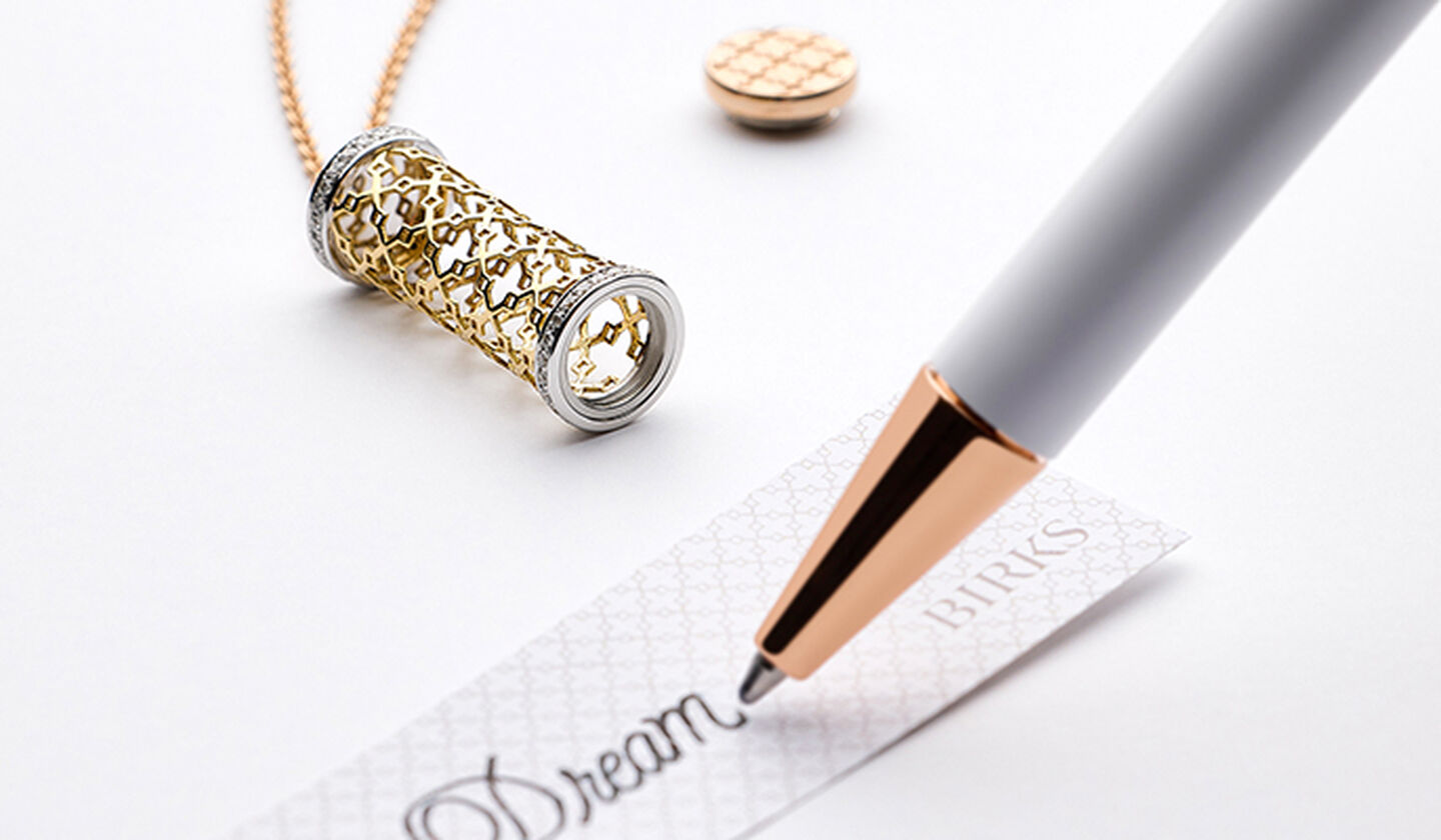 A Birks Dare to Dream tri-gold message pendant.