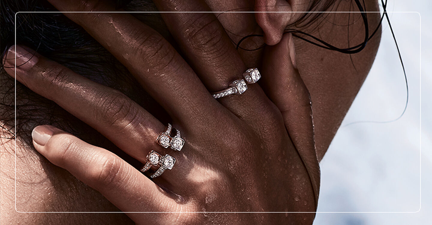 Woman's hand on her neck with Le Cube Diamant diamond rings