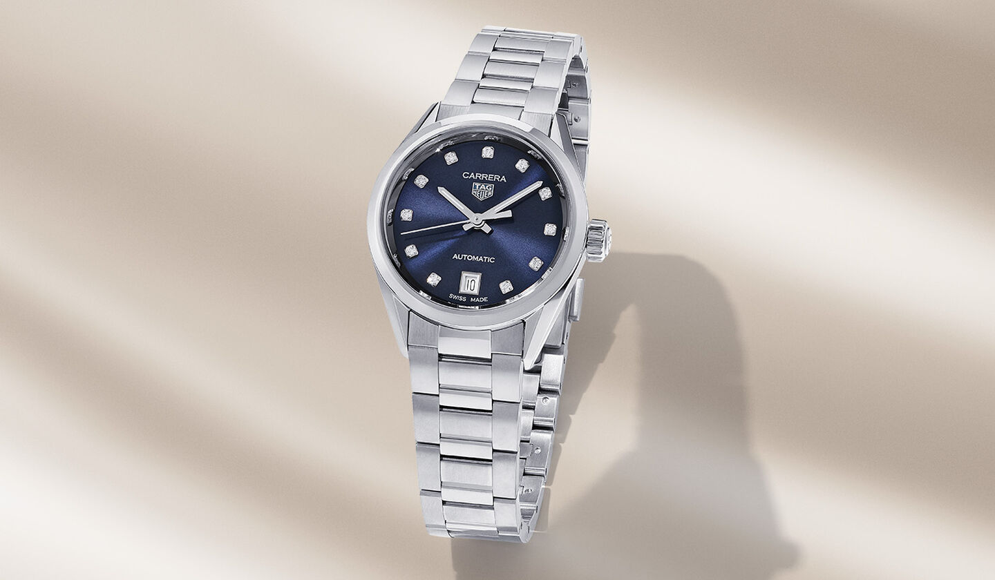 TAG Heuer Carrera watch on a beige background.