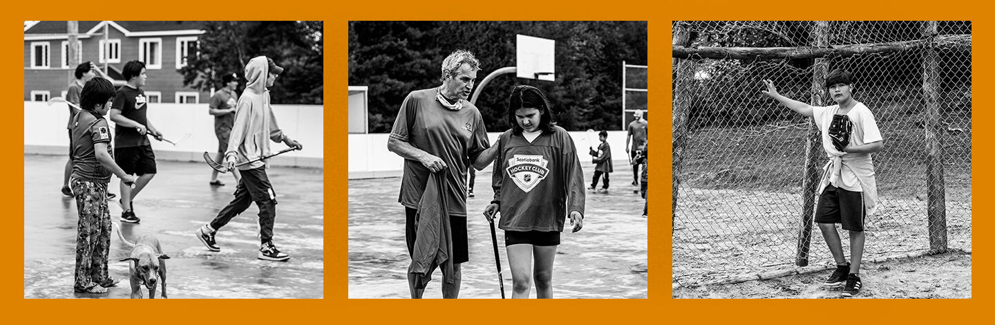 black and white photo of an older man, and young girl talking on a basketball court
