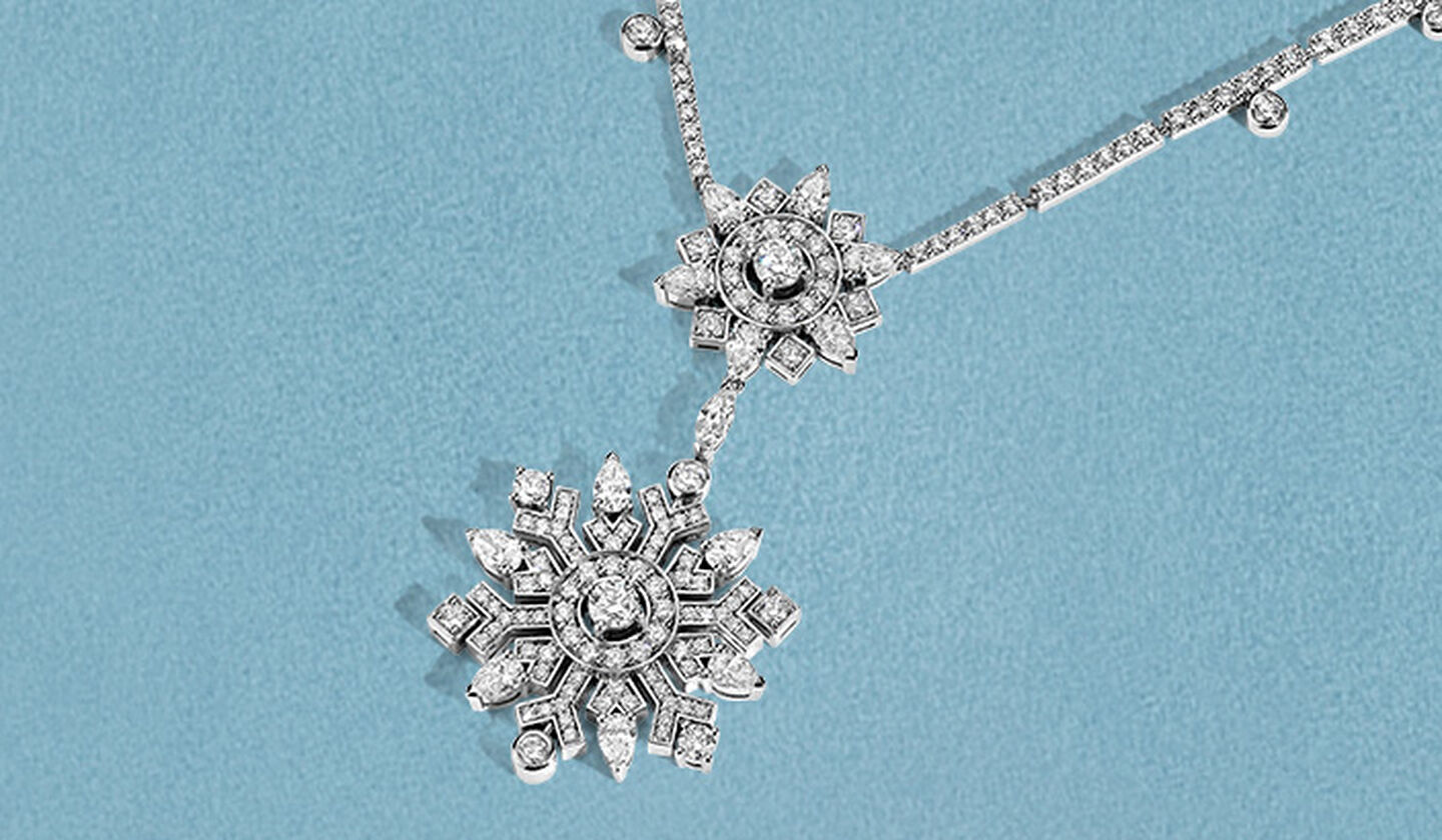 Birks Snowflake High Jewellery diamond necklace on a blue background.