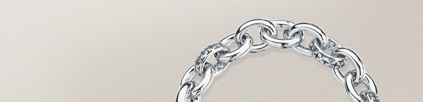 Birks Muse silver link bracelet on a greyish-beige background
