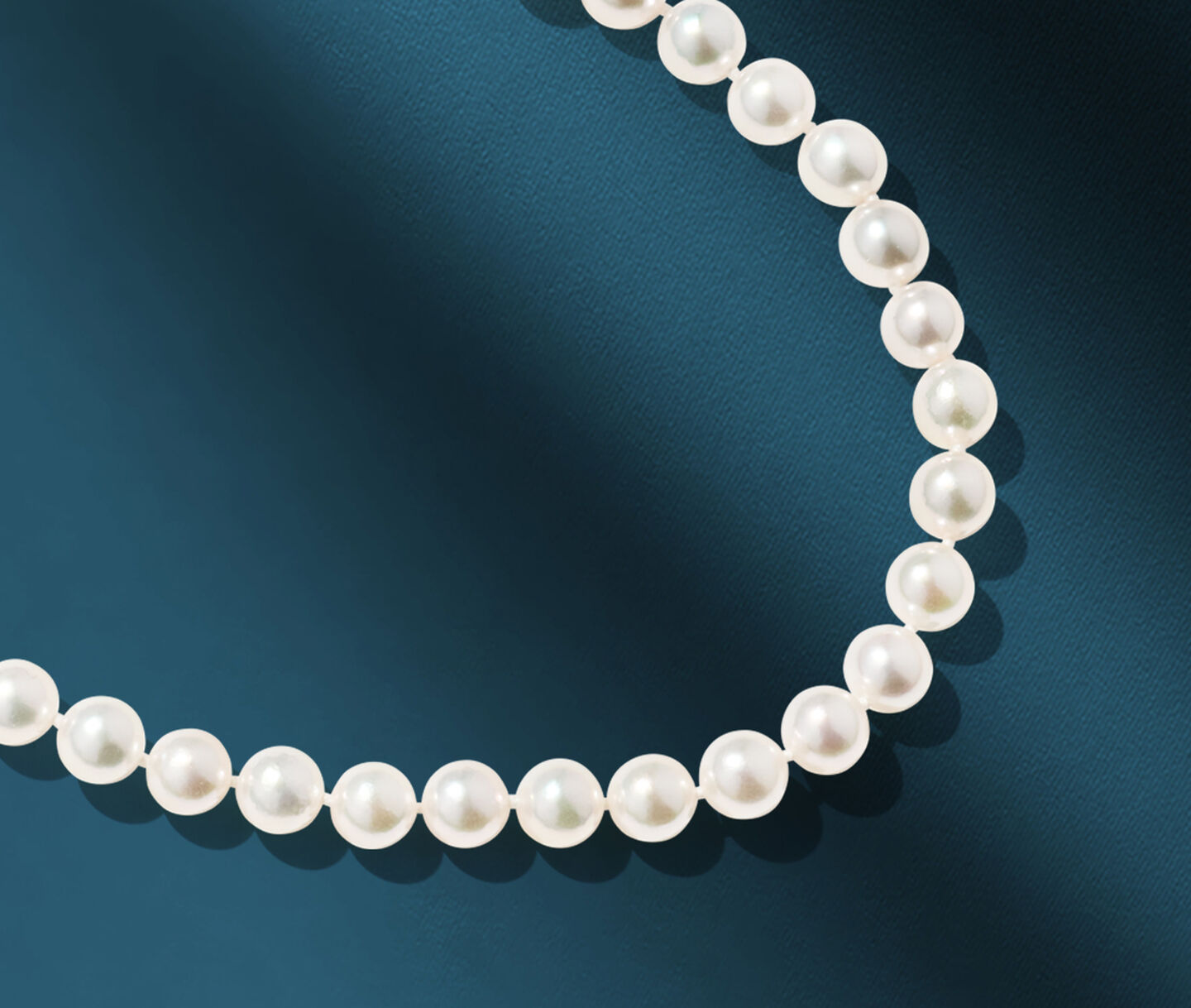 Biks Pearls necklace on a blue background.