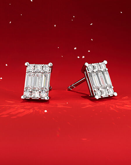 Birks Essentials diamond earrings on a red background.