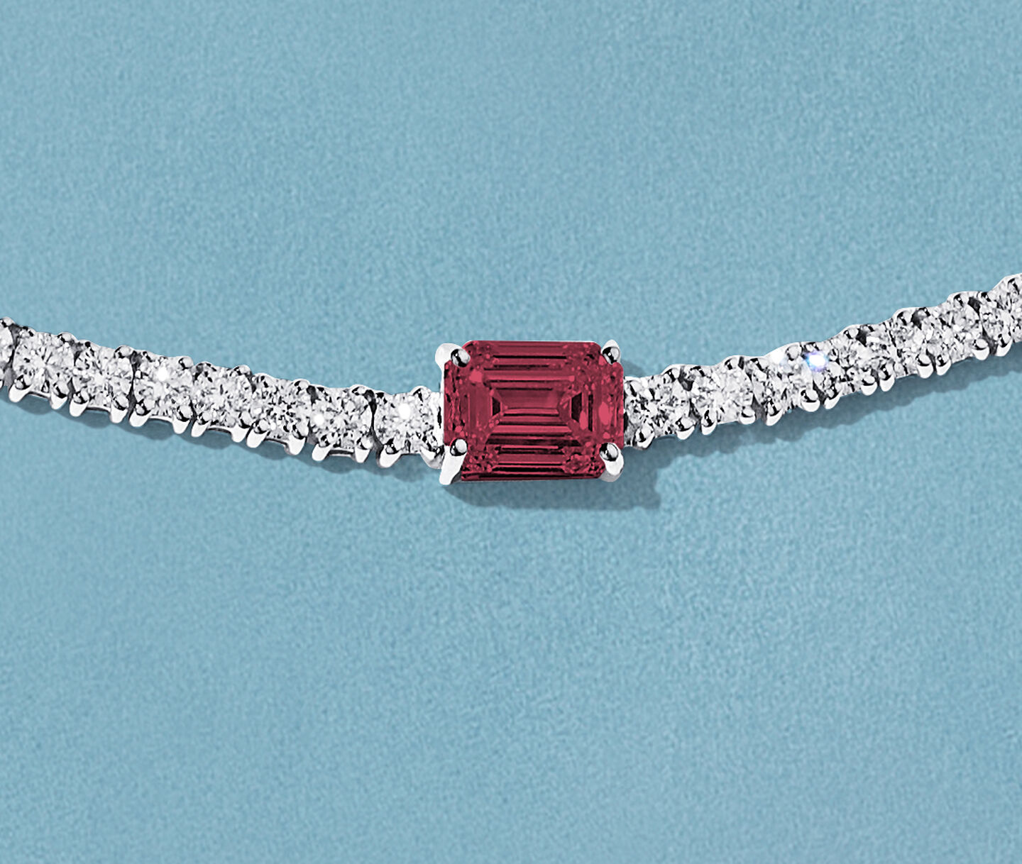 Birks Essentials ruby and diamond bracelet on a blue background.