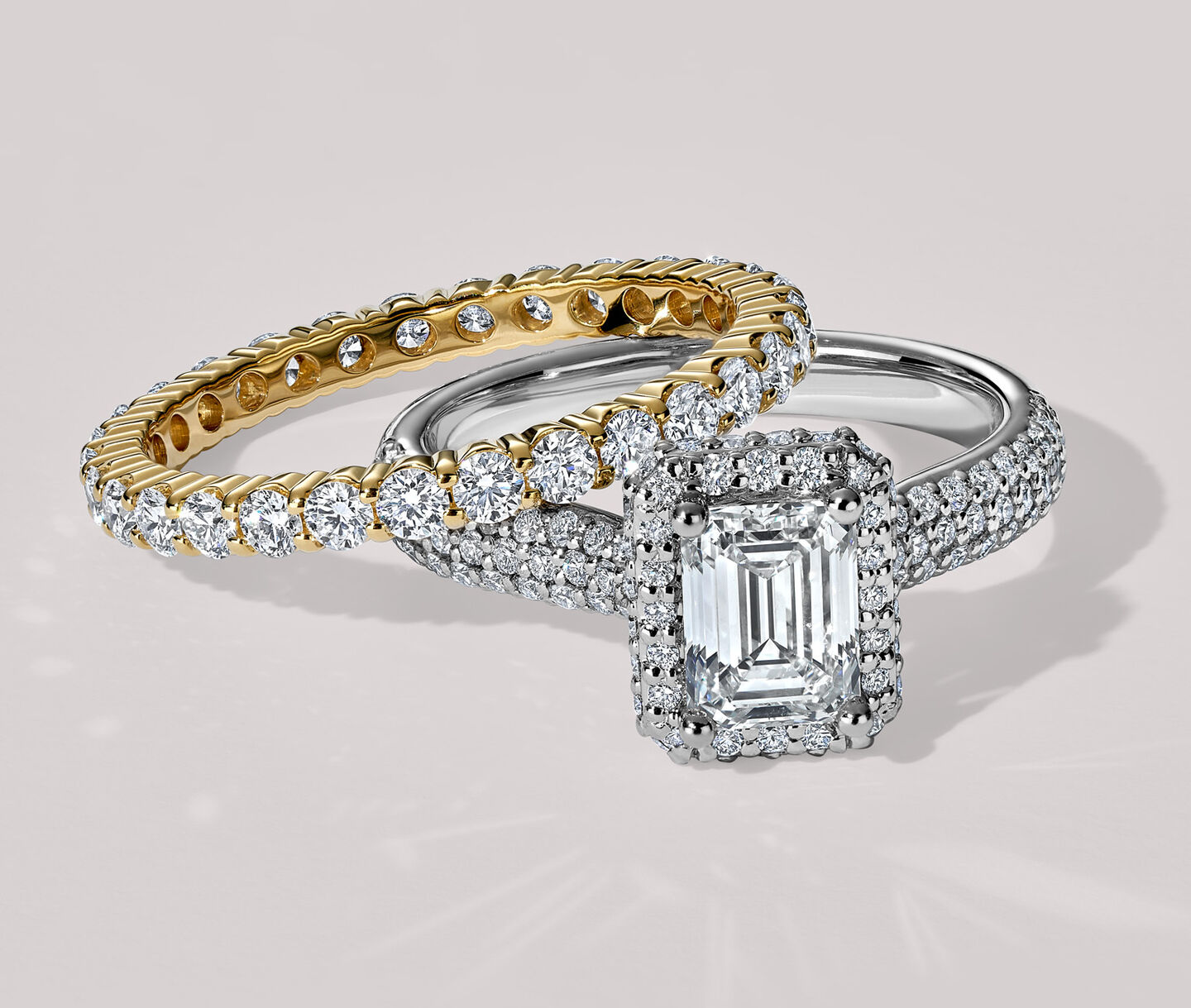 A Birks diamond engagement ring with pavé band and eternity band on a blue box.
