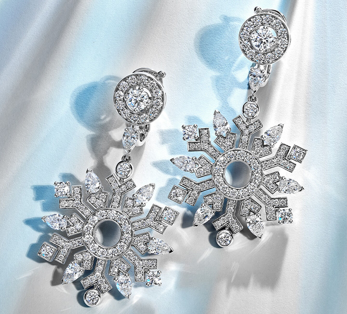 a pair of Snowflake shaped diamond earrings