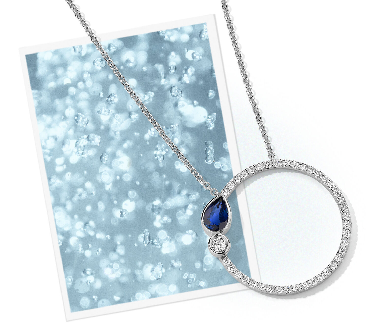 Birks Splash sapphire circle pendant on a photograph of water bubbles