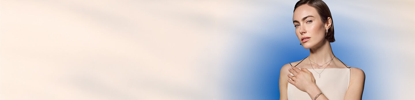 A woman wearing Maison Birks diamond jewellery. 