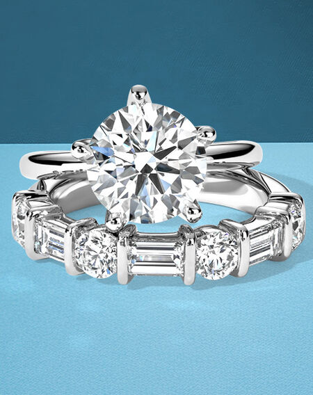 Birks North Star engagement ring and diamond wedding band on a blue background.