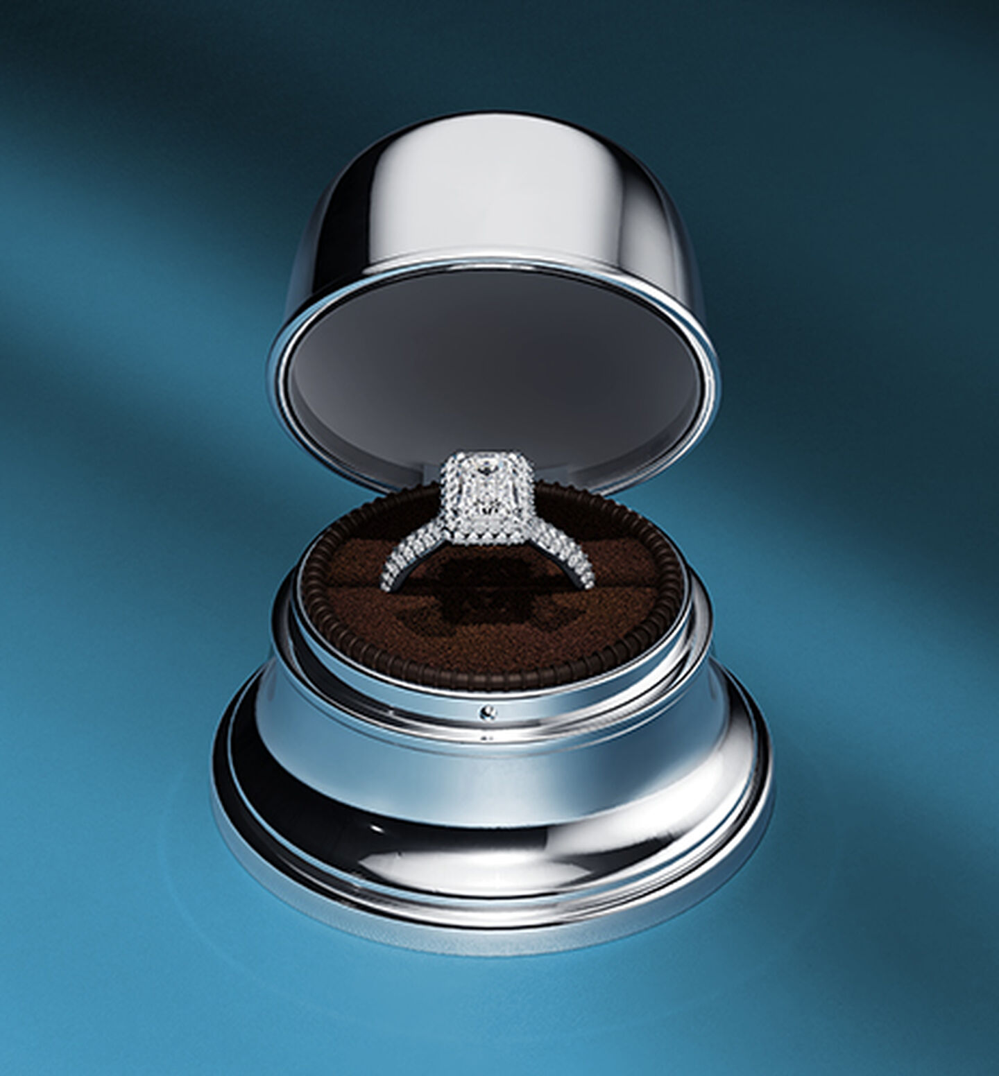 A Birks 1879 engagement ring in a Birks Bell Box on a dark blue background.