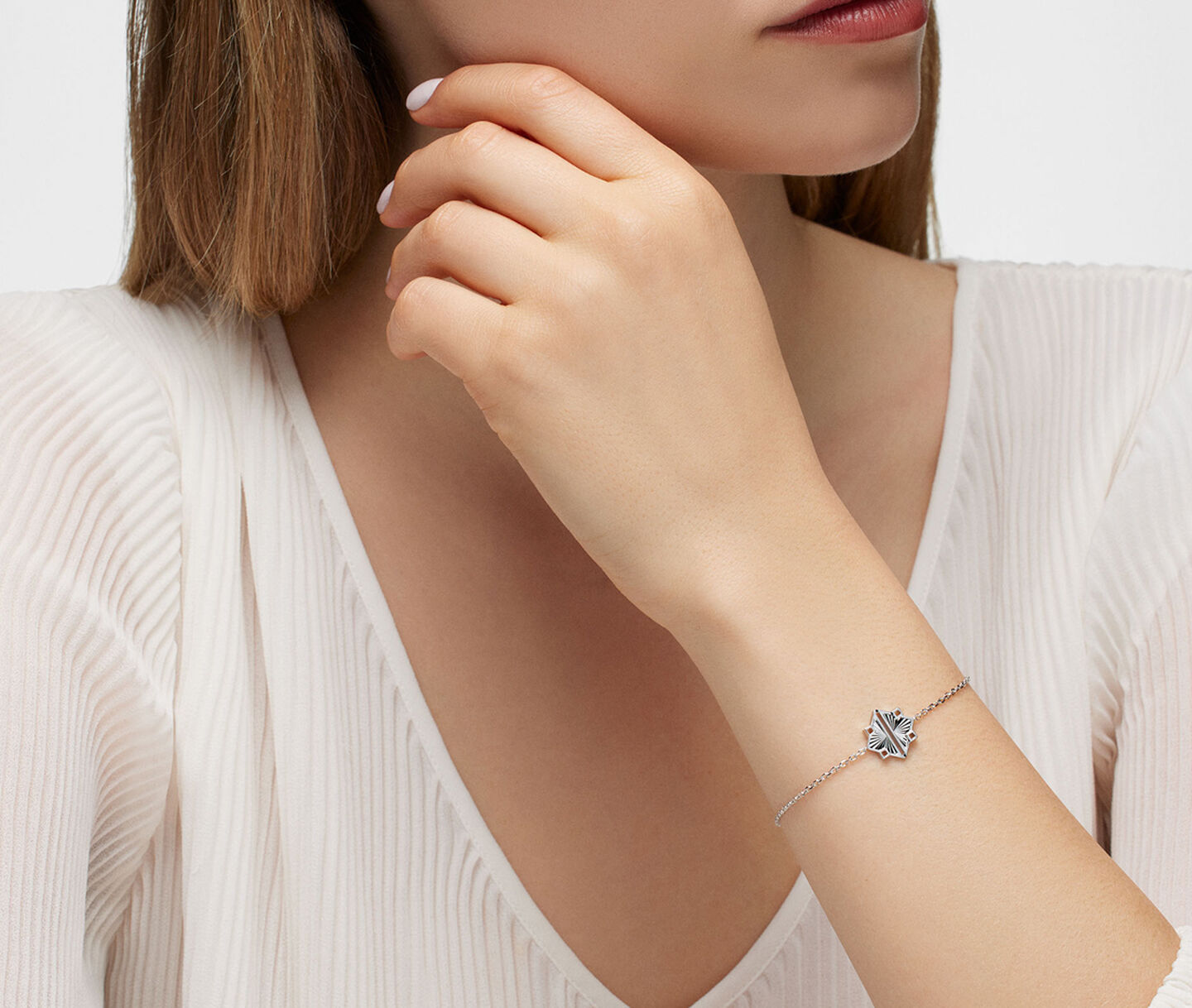 A woman wearing Birks muse silver bracelet.