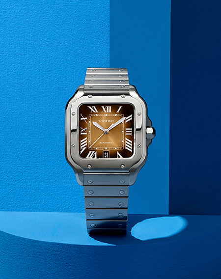 Santos de Cartier watch on a blue background.