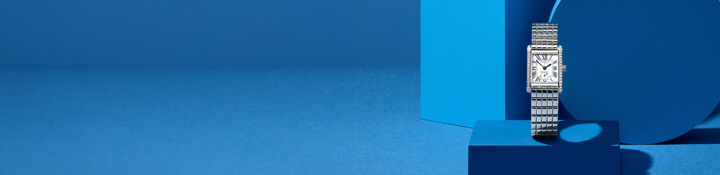 Longines DolceVita women's watch on a blue background.