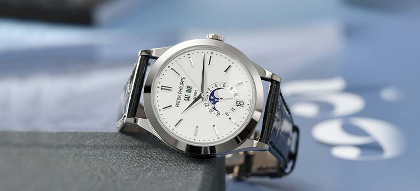 Silver watch with a white face and leather band