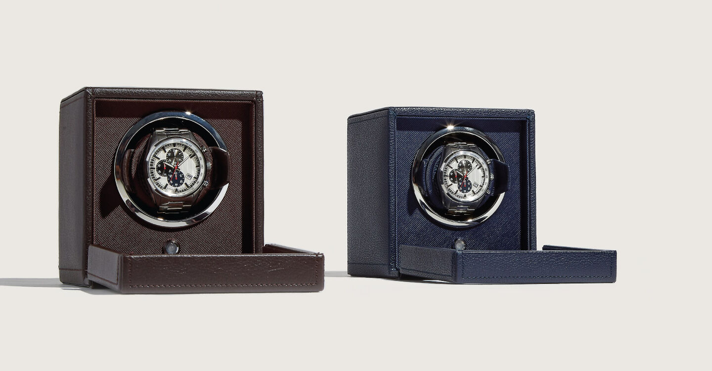 Two black and navy blue single watch winder sitting side by side