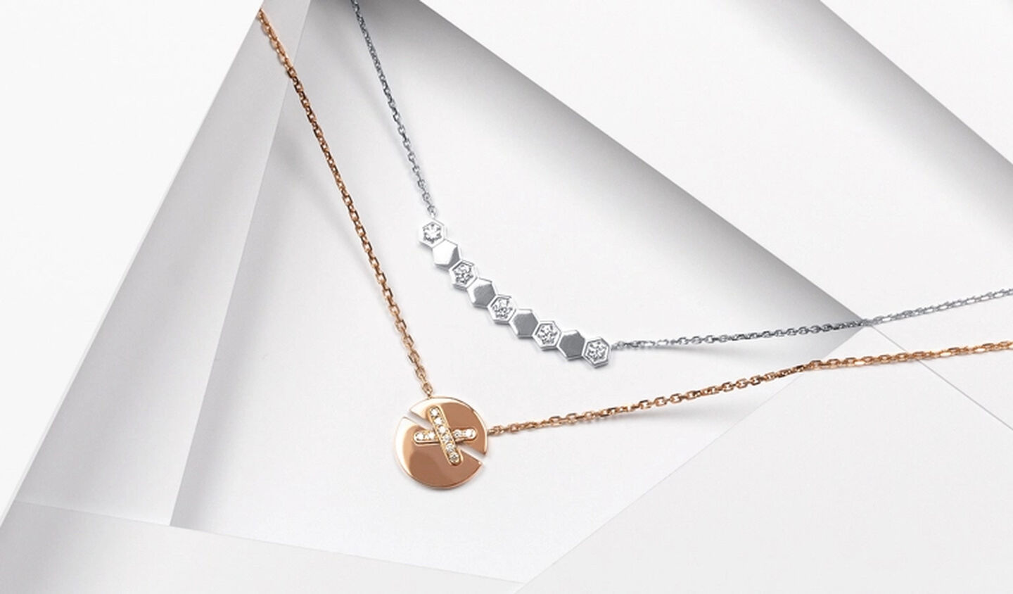 A Chaumet Jeux de Liens Harmony pendant below a white gold Chaumet Bee My Love necklace