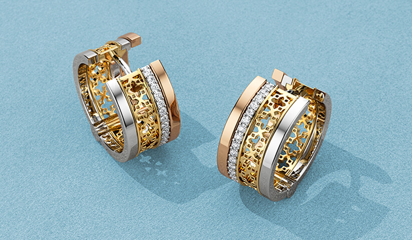 Birks Dare to Dream tri-gold earrings on a blue background.