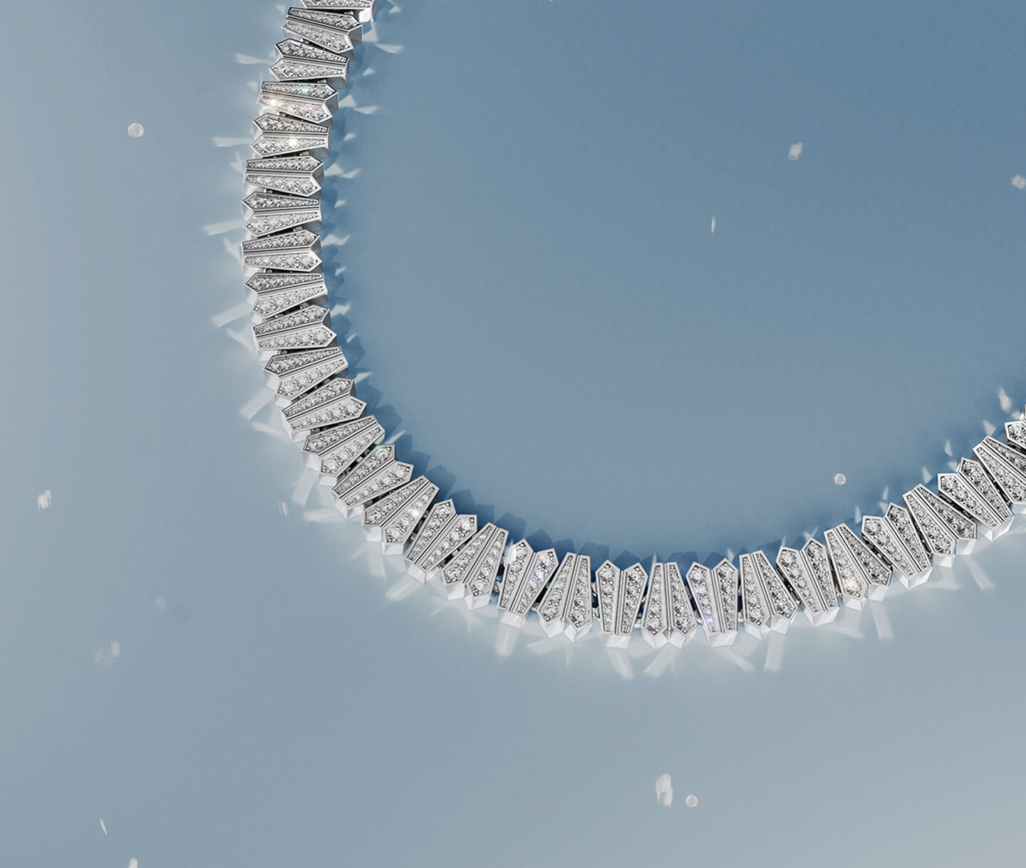 Birks Beekeeper yellow gold bangle on a blue snowy background.