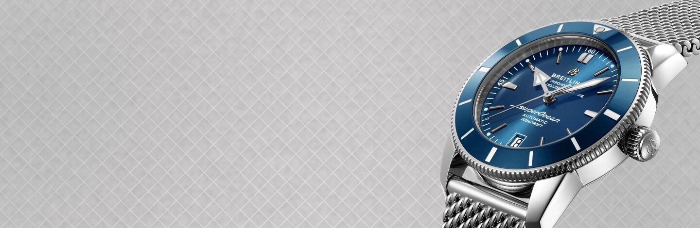 blue watch face and dial with a steel mesh band