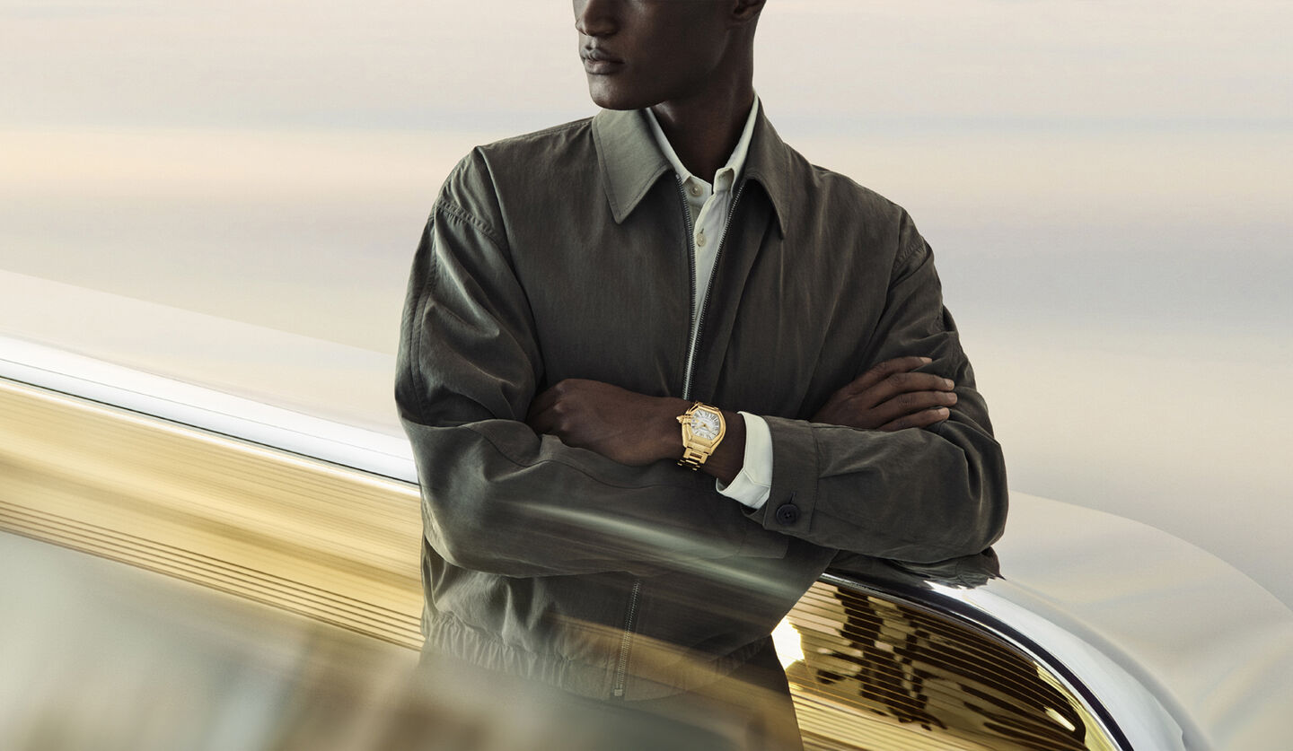 A man wearing a Cartier Roadster watch.