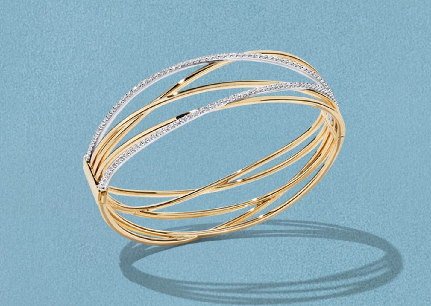 Birks Rosee du Matin gold and diamond bracelet on a blue background.