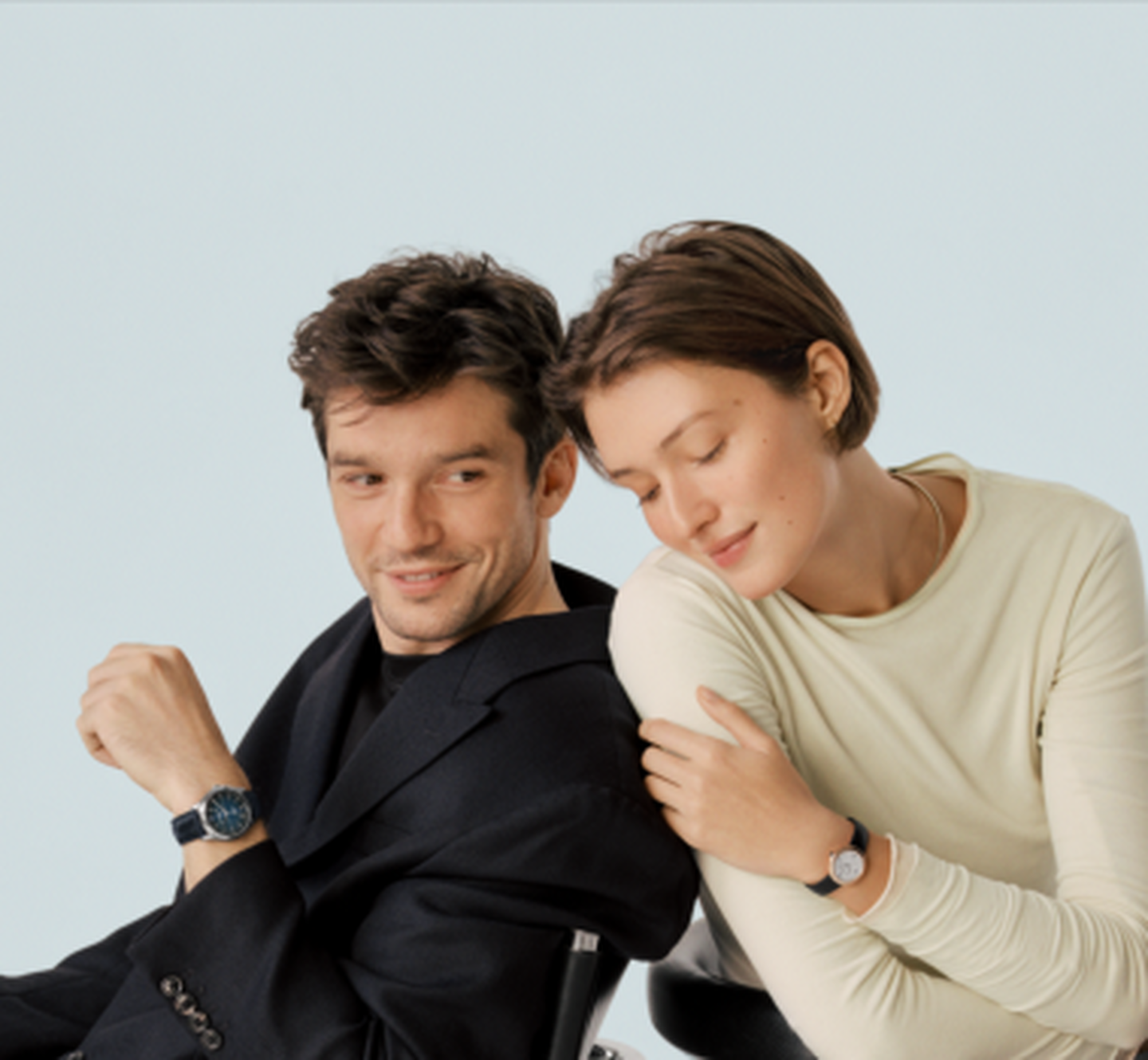 A man and woman wearing Baume & Mercier watches.