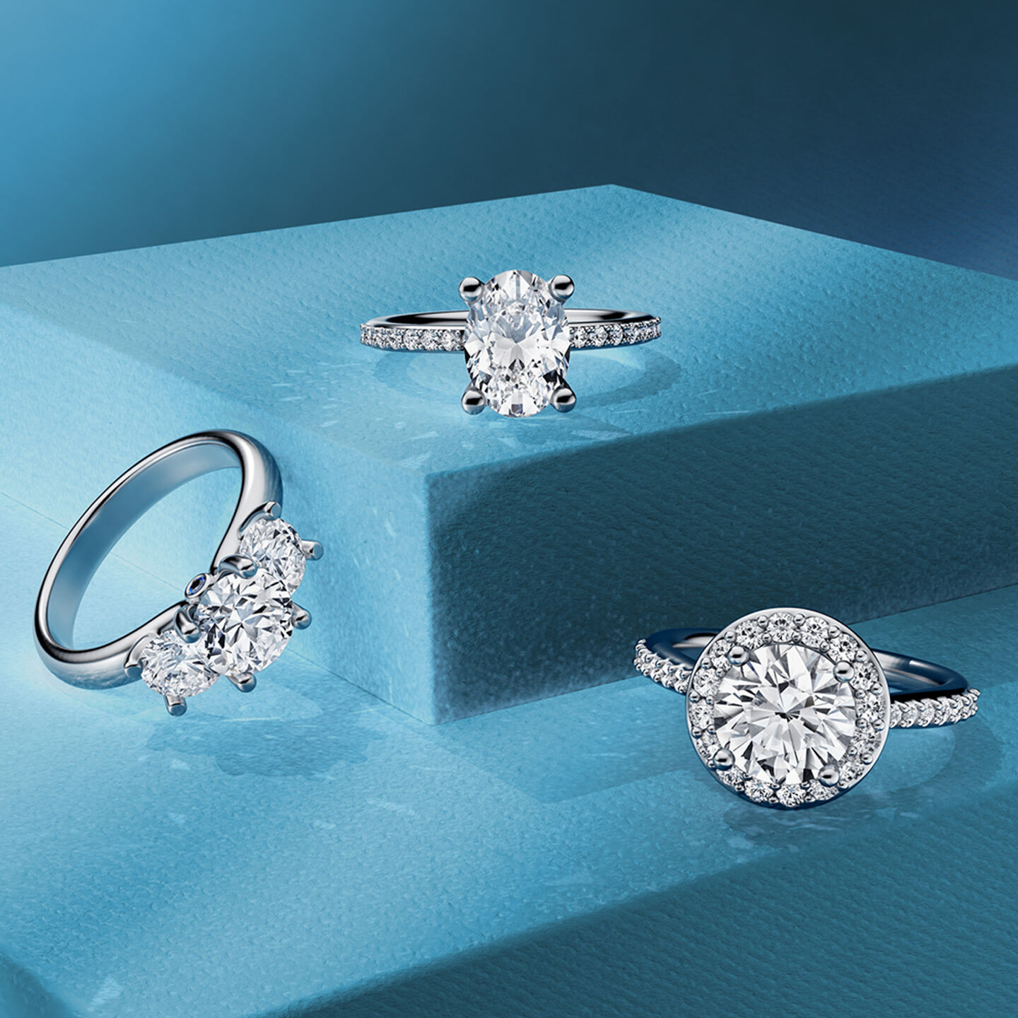 Three Birks diamond engagement rings on a white background.