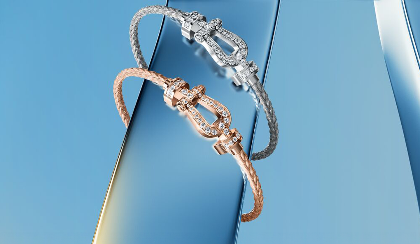 Two FRED Force 10 bracelets from FRED on a blue background.