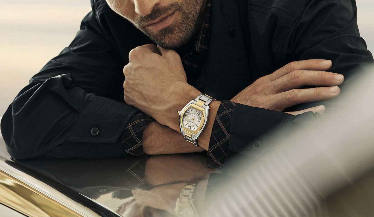 A man wearing a Cartier Roadster watch.