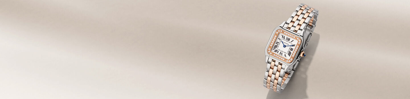 Panthere de Cartier watch on a beige background.