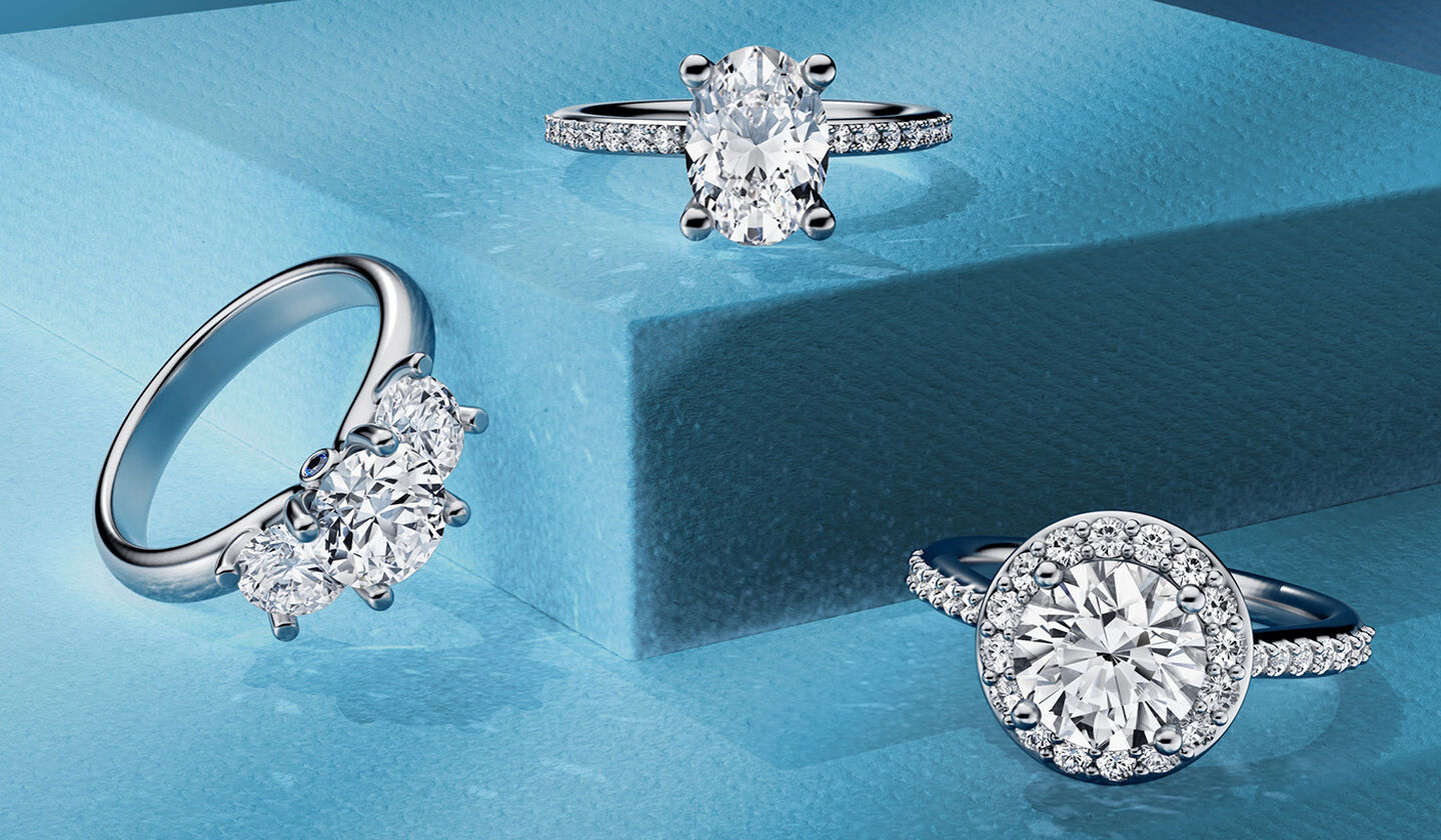 Birks diamond engagement rings on a blue background.