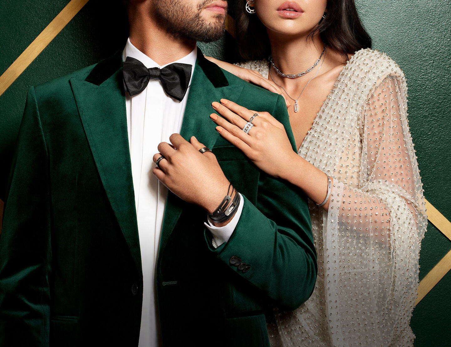 A man and woman dressed for the holiday season in Messika jewellery.