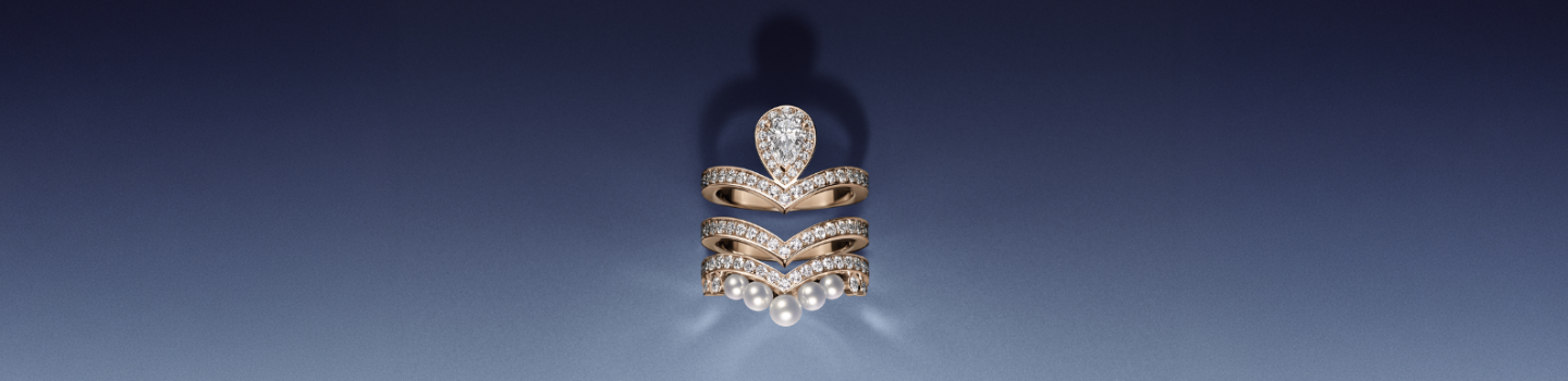 Chaumet Josephine diamond engagement ring with diamond band on a blue background.