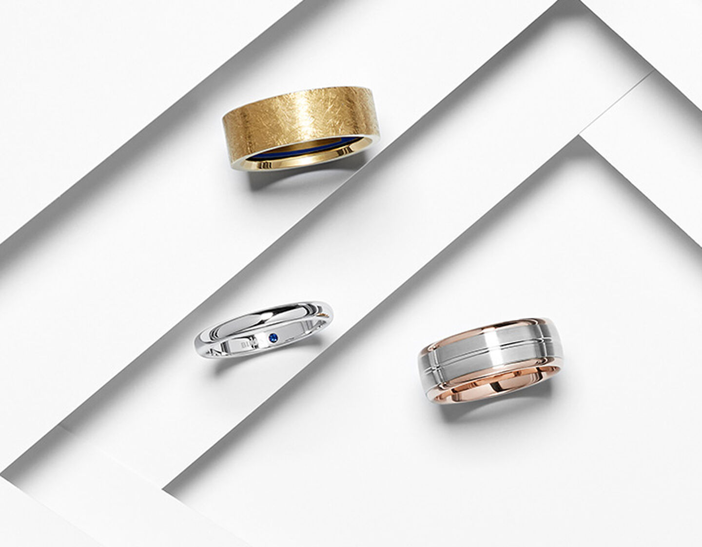 Birks wedding bands on a white layered background.