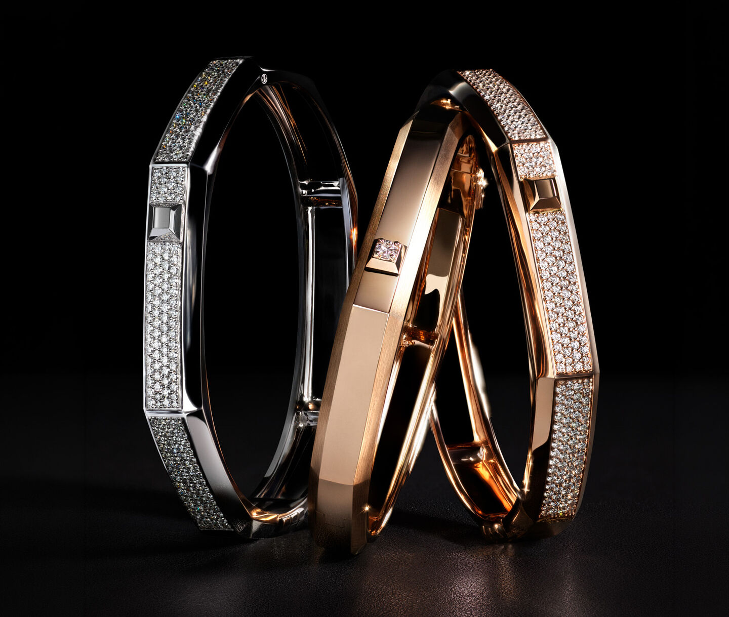Messika Moderniste gold and diamond bracelets on a black background.