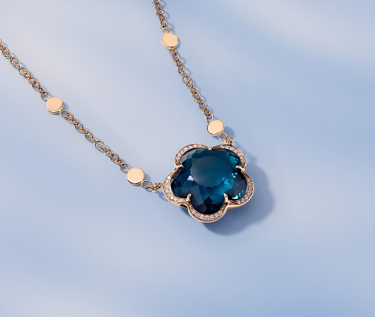 Pasquale Bruni Bon Ton pendant necklace on a blue background.