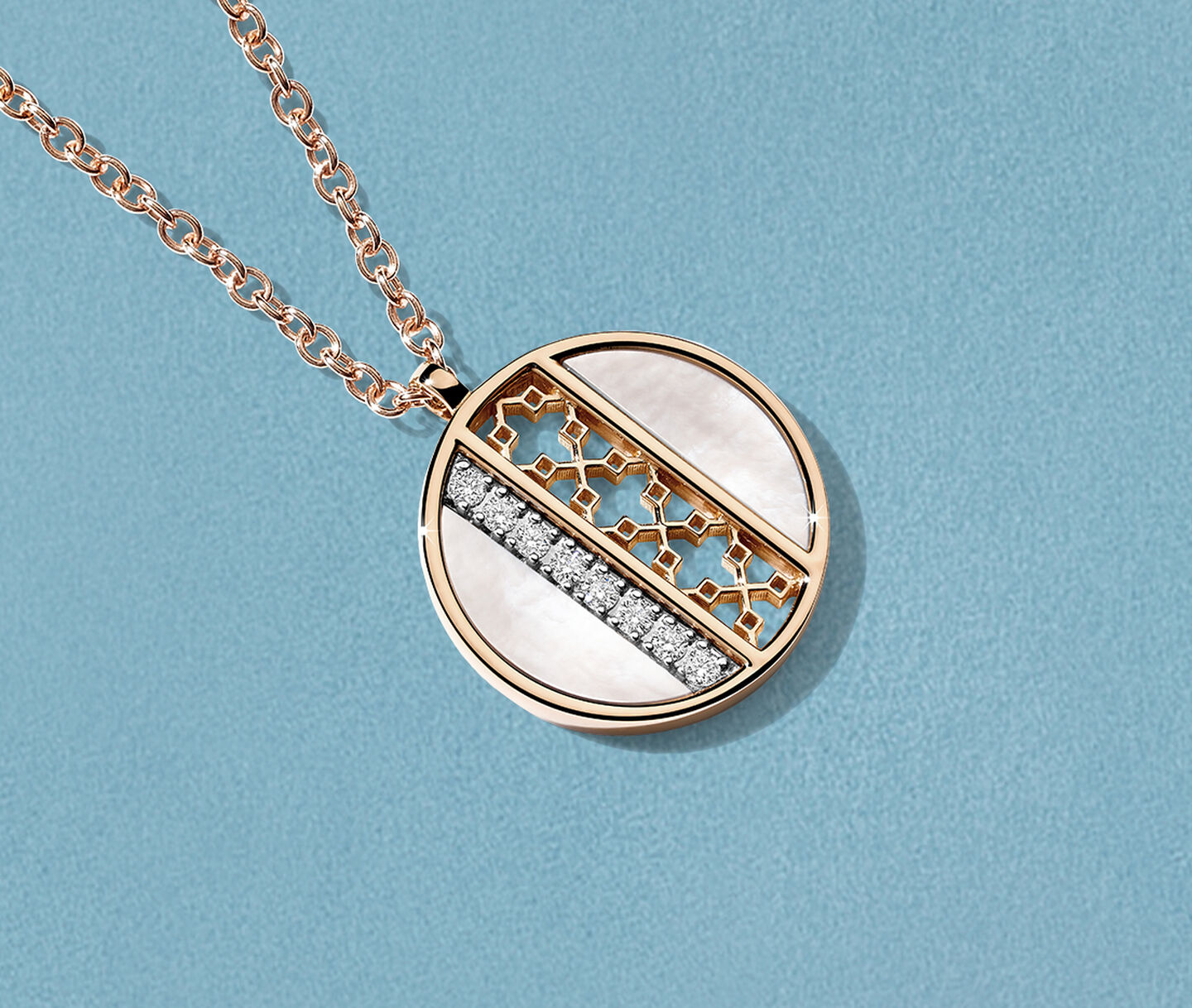 Birks Dare to Dream mother-of-pearl medallion necklace on a blue background.